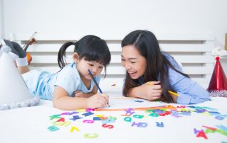 Mother and daughter studying the alphabet together, a bonding activity to enhance early literacy skills